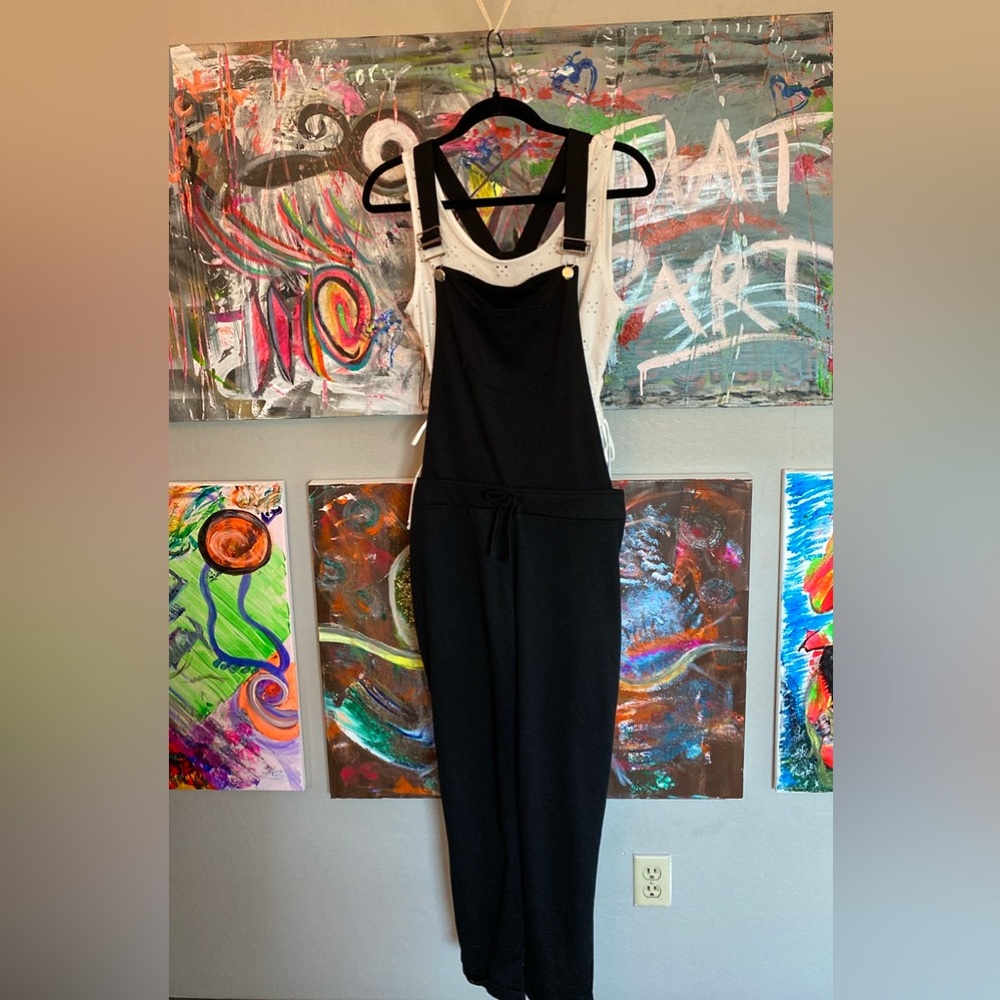 Stretchy black knit overalls and white sleeveless top